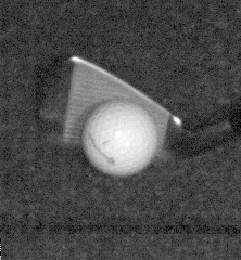 A face-on still of a wedge face meeting the ball